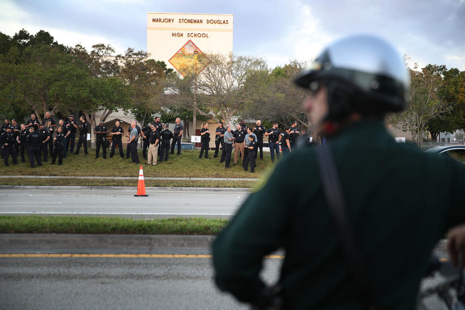 &nbsp;Police officers stand in front of Marjory Stoneman Douglas High School as student arrive.
