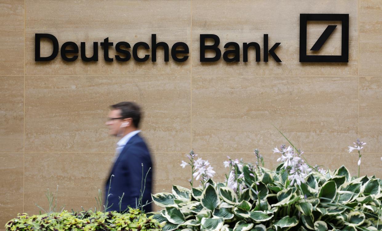 A pedestrian walks past a logo outside the offices of German bank Deutsche Bank in central London on July 8, 2019. - Germany's biggest lender Deutsche Bank said Sunday it would cut 18,000 jobs by 2022, as the former leading light of the country's financial sector looks to escape years of turmoil. With almost 8,000 staff, Deutsche Bank is one of the biggest employers in the City of London. (Photo by Tolga AKMEN / AFP)        (Photo credit should read TOLGA AKMEN/AFP/Getty Images)