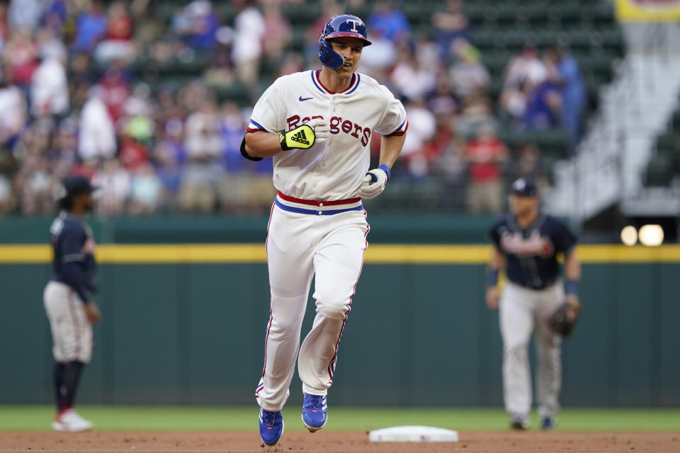 Texas Rangers Corey Seager (5) runs the bases after hitting a solo home run during the first inning of the team's baseball game against the Atlanta Braves in Arlington, Texas, Saturday, April 30, 2022. (AP Photo/LM Otero)