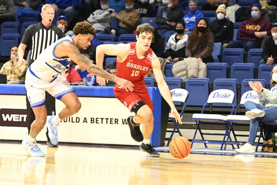 Bradley freshman guard Connor Hickman drives past Tremell Murphy on the way to a career-high 15 points in an 83-71 win over Drake at Knapp Center in Des Moines, Iowa on Wednesday, Jan. 19, 2022.