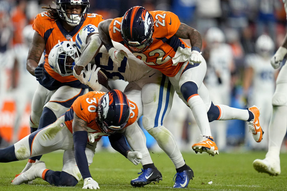Denver Broncos safety Kareem Jackson (22) hits Indianapolis Colts running back Deon Jackson (35) during the second half of an NFL football game, Thursday, Oct. 6, 2022, in Denver. (AP Photo/Jack Dempsey)