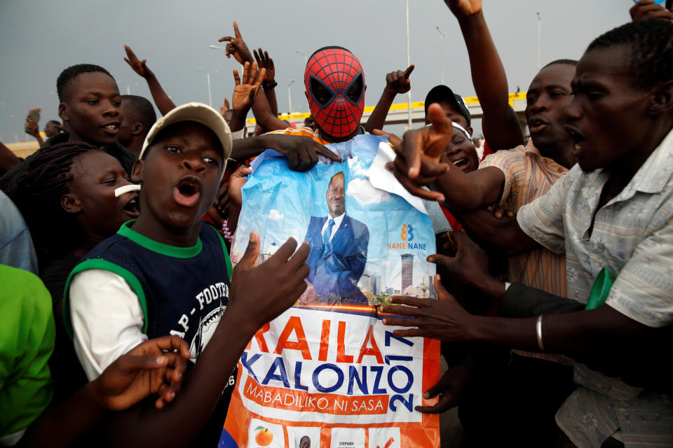 <p>People react as they hold a poster depicting Kenyan opposition leader Raila Odinga, the presidential candidate of the National Super Alliance (NASA) coalition, in Kisumu, Kenya, Aug.10, 2017. (Photo: Baz Ratner/Reuters) </p>