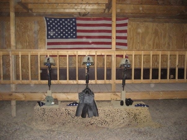 A memorial display at Camp Dublin in Baghdad, Iraq, honors fallen heroes who died July 6, 2007: Petty Officer First Class Steve Daugherty (cryptologic technician), Petty Officer First Class Jason Lewis (SEAL), and Petty Officer First Class Bobby McRill (combat photographer).