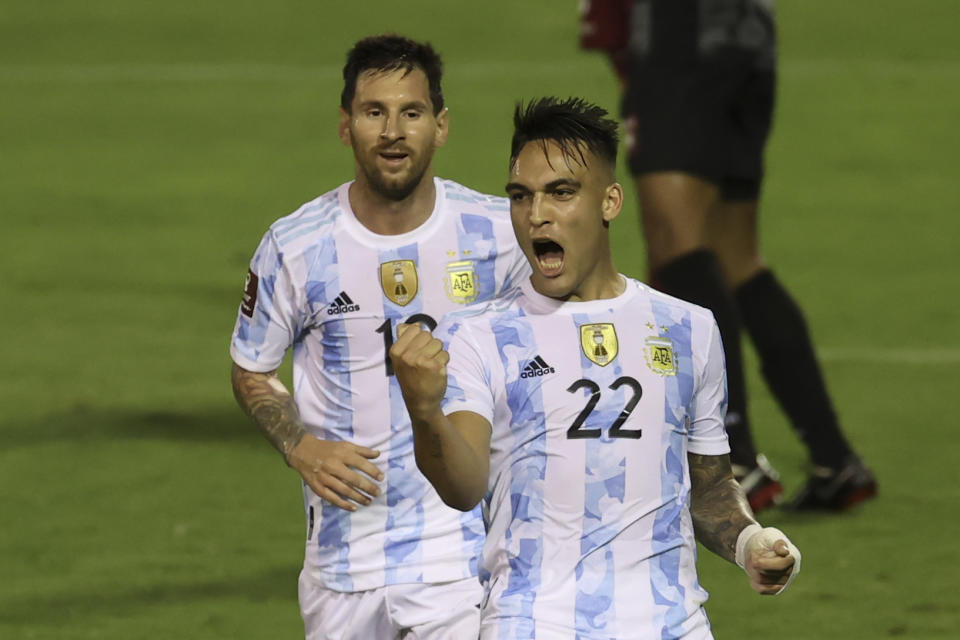 Argentina&#39;s Lautaro Martinez, right, celebrates scoring the opening goal against Venezuela beside teammate Lionel Messi during a qualifying soccer match for the FIFA World Cup Qatar 2022 in Caracas, Venezuela, Thursday, Sept. 2, 2021. (Miguel Gutierrez, Pool via AP)