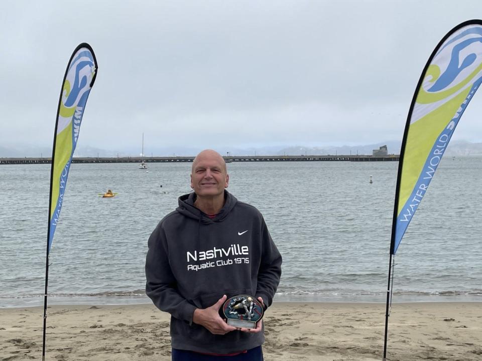 Swimmer Don Cooper poses with this third-place award after swimming around Alcatraz in San Francisco, Calif., Saturday, July 9, 2022.