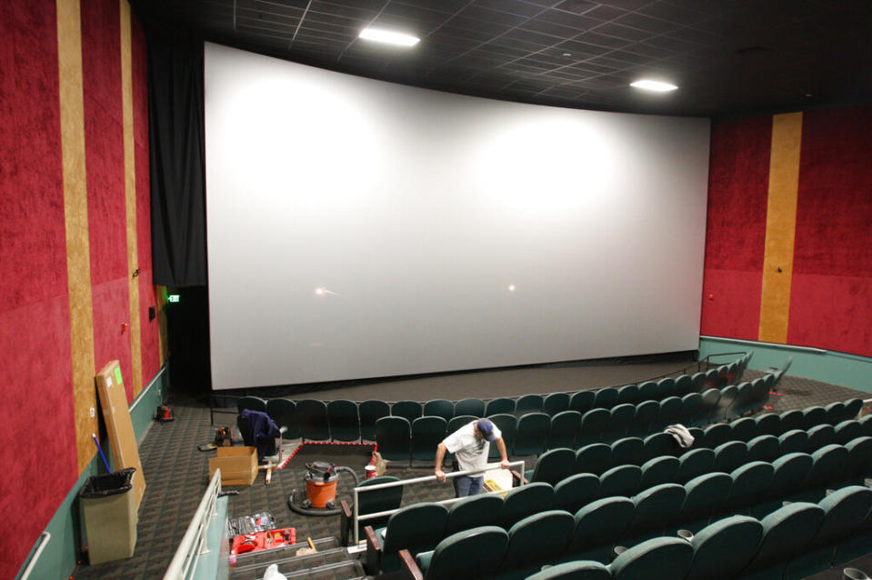 Workers put together the finishing touches on the new IMAX theatre inside the AMC Showplace Edwardsville 12 Thursday Dec. 15, 2011, in Edwardsville, Illinois - Credit: AP