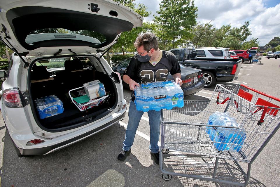 Tyler Anderson loads up on water and other supplies at a Costco on Sept. 13 as New Orleans prepares for the arrival of Hurricane Sally.