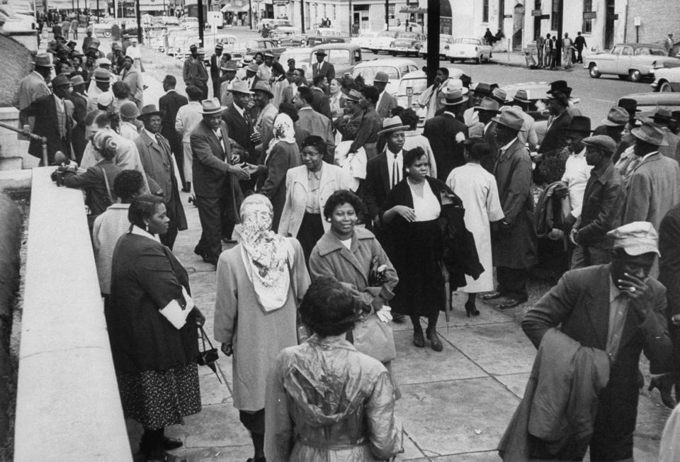 A group of African Americans, standing in front of Capitol Building steps, during the bus boycott.