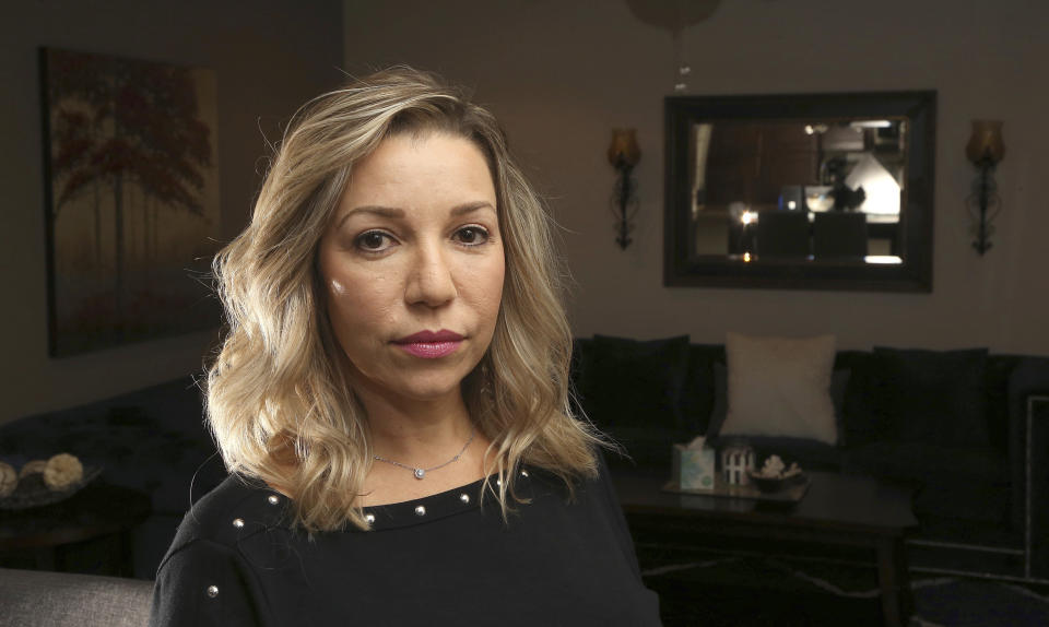 Rebecca Tiger, a former Phoenix police officer, is the widow of Craig Tiger, a Phoenix police officer who committed suicide a few years ago following a fatal shooting he was involved in, shown here at her home Monday, July 1, 2019, in Scottsdale, Ariz. Officer Craig Tiger suffered from post-traumatic stress disorder after fatally shooting a man while on duty back in 2012, and took his own life two years later. (AP Photo/Ross D. Franklin)