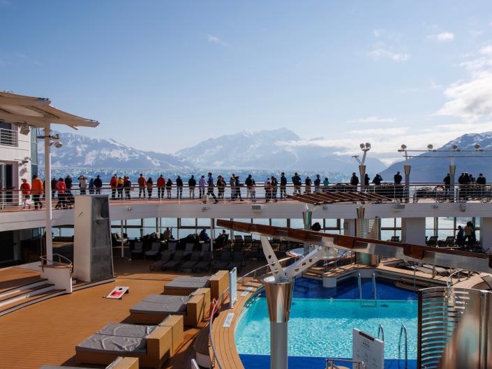 Image of pool deck on cruise with Alaska landscape in the background