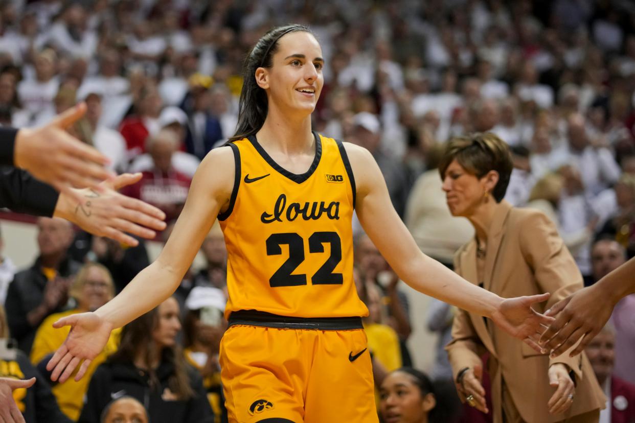 Feb 22, 2024; Bloomington, Indiana, USA; Iowa Hawkeyes guard Caitlin Clark (22) high-fives teammates as she takes the court before the game against the Indiana Hoosiers at Simon Skjodt Assembly Hall.