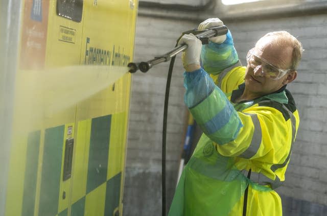 Liberal Democrats leader Sir Ed Davey washes an ambulance 