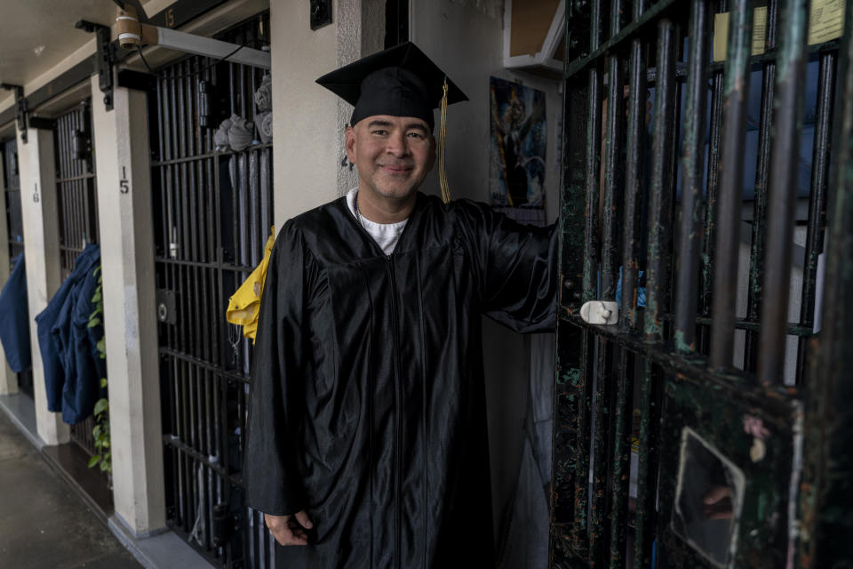 Manuel Martinez, who earned a bachelor's degree in communications through the Transforming Outcomes Project at Sacramento State (TOPSS), stands for a portrait outside his cell after a graduation ceremony at Folsom State Prison in Folsom, Calif., Thursday, May 25, 2023. Thousands of prisoners throughout the United States get their college degrees behind bars, most of them paid for by the federal Pell Grant program, which offers the neediest undergraduates tuition aid that they don’t have to repay. That program is about to expand exponentially in July, giving tens of thousands more students behind bars financial aid per year. (AP Photo/Jae C. Hong)