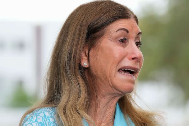 PHOTO: Linda Beigel Schulman, mother of Scott Beigel, is overcome with emotion as she talks to journalists about visiting the scene where her son and 16 others were killed, at Marjory Stoneman Douglas High School in Parkland, Fla., July 5, 2023. (Rebecca Blackwell/AP)