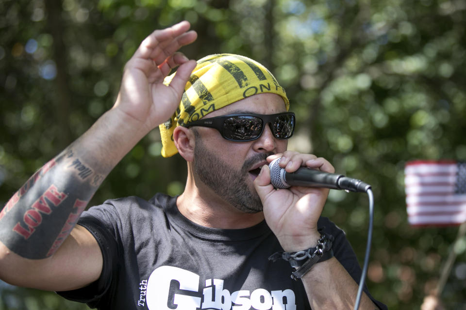 FILE - In this Aug. 4, 2018 file photo, Patriot Prayer founder and rally organizer Joey Gibson speaks to his followers at a rally in Portland, Ore. On Friday, Aug. 16, 2019 authorities announced they&#39;ve arrested Gibson, the leader of the right-wing group, on the eve of a far-right rally that&#39;s expected to draw people from around the U.S. to Portland on Saturday, Aug. 17, prompting Gibson to urge his followers to &quot;show up one hundred-fold&quot; in response. (AP Photo/John Rudoff, File)