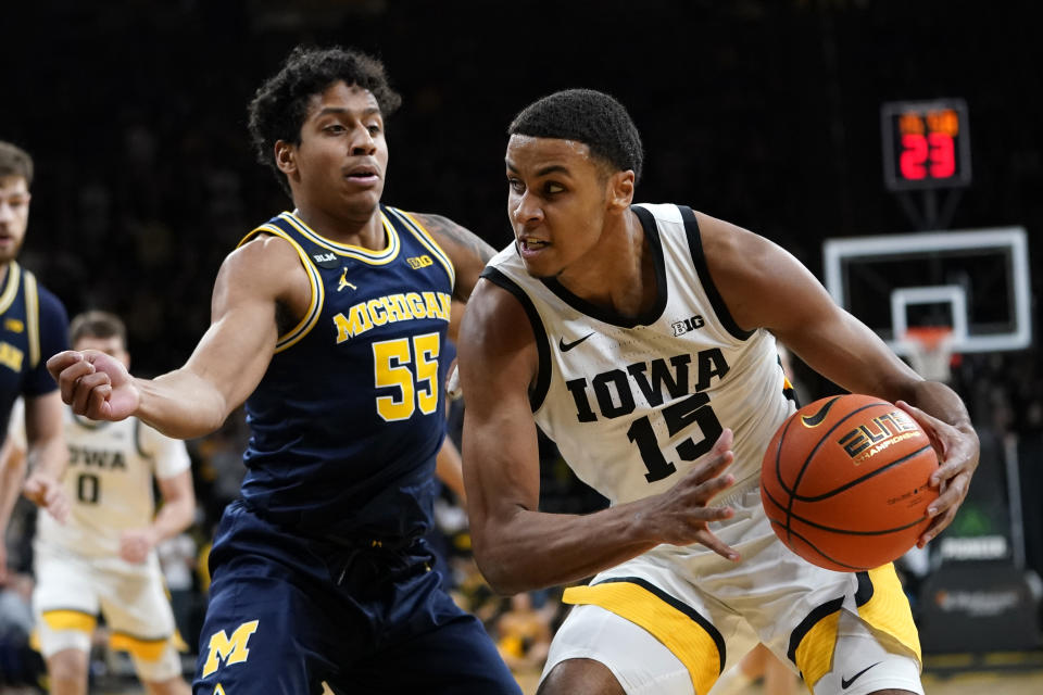 Iowa forward Keegan Murray (15) drives to the basket past Michigan guard Eli Brooks (55) during the second half of an NCAA college basketball game, Thursday, Feb. 17, 2022, in Iowa City, Iowa. (AP Photo/Charlie Neibergall)