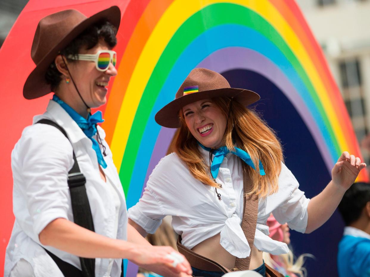 Women with "Mountie" hats dance on a float during the Pride Parade in Toronto, Ontario, June 25, 2017.