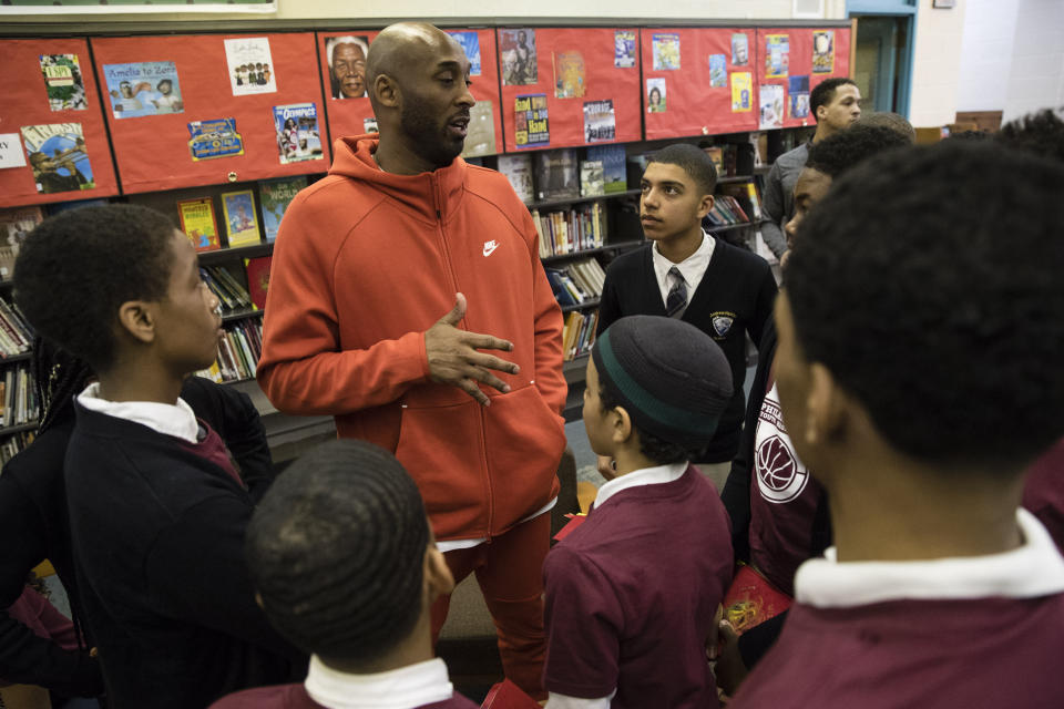 Former Los Angeles Lakers NBA basketball player Kobe Bryant meets with students at Andrew Hamilton School in Philadelphia, Thursday, March 21, 2019. Kobe Bryant was promoting the book The Wizenard Series: Training Camp he created with writer Wesley King. (AP Photo/Matt Rourke)