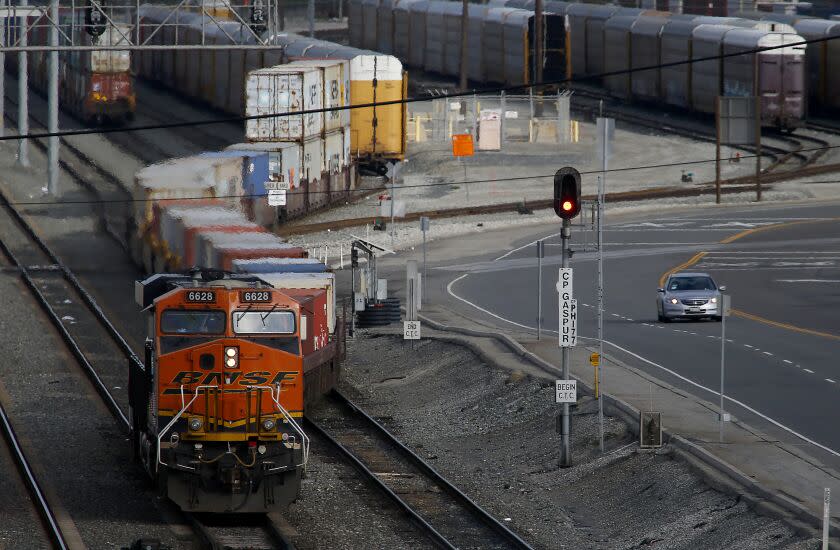 LONG BEACH, CALIF. -MAR. 14, 2020. A diesel locomotive hauls cargo from the Port of Long Beach on Saturday, Mar. 14, 2020. Shipping executives say that the global coronavirus pandemic may cause a 20 percent drop in goods arriving in west coast ports like Los Angeles and Long Beach. (Luis Sinco/Los Angeles Times)