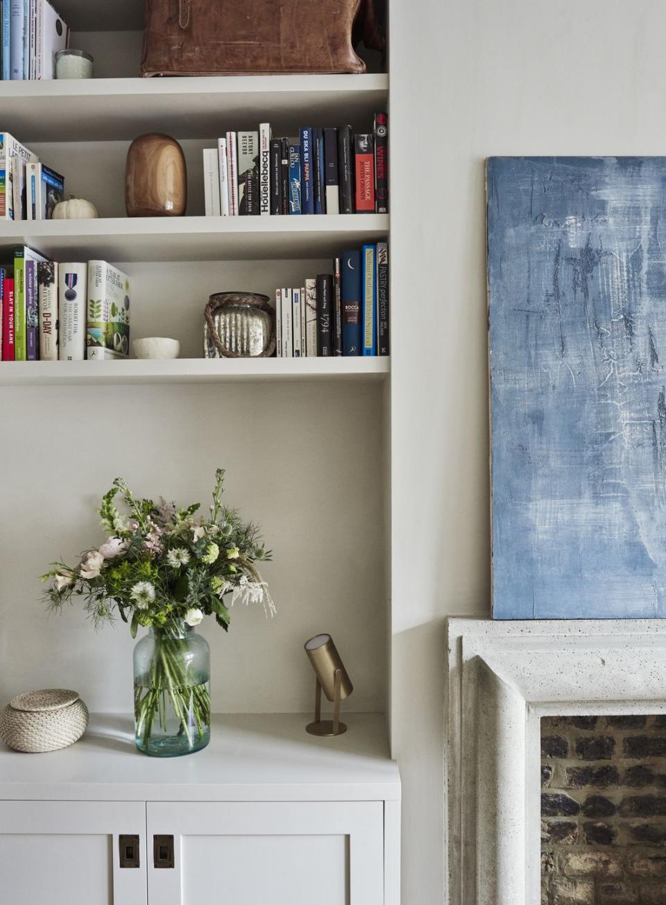 built in alcove shelves in a living room painted in off white lime paint