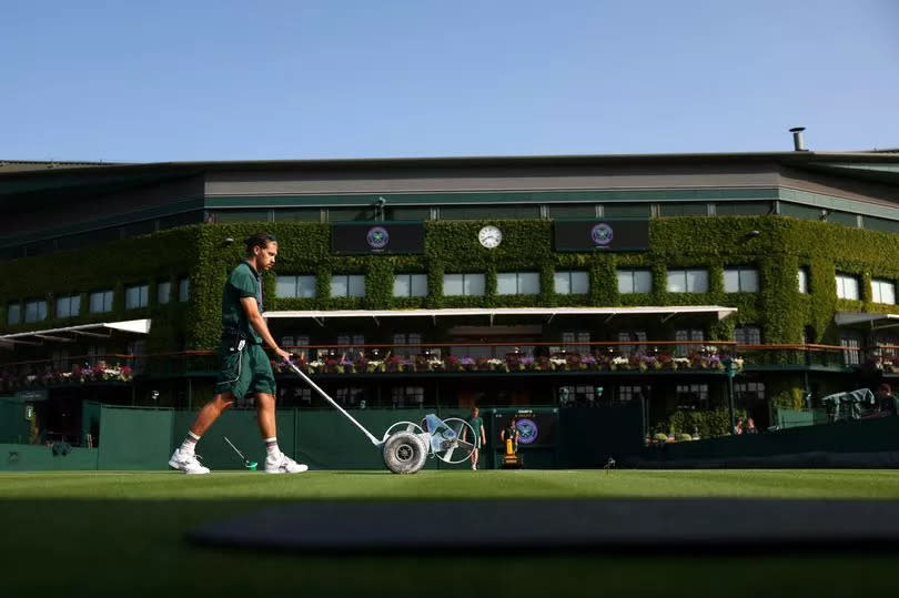 LONDON, ENGLAND - JULY 03: A member of the grounds team is seen painting a line prior to day one of The Championships Wimbledon 2023 at All England Lawn Tennis and Croquet Club on July 03, 2023 in London, England. (Photo by Michael Regan/Getty Images)