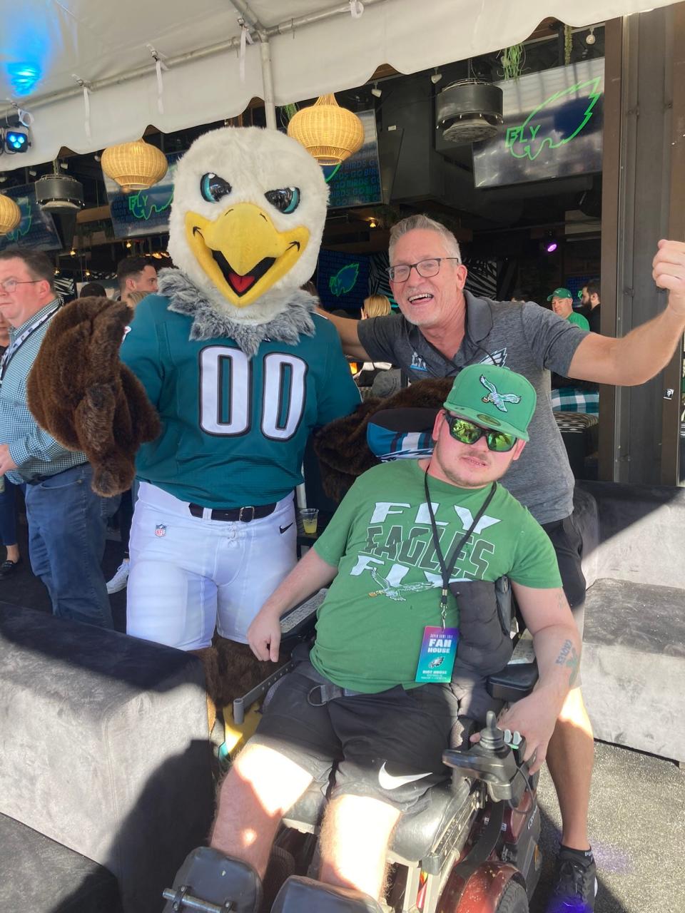 Austin Lauer (bottom right) and his father George Lauer with Swoop, the Philadelphia Eagles' mascot, at the Eagles' VIP tailgate party prior to Super Bowl LVII in Arizona.