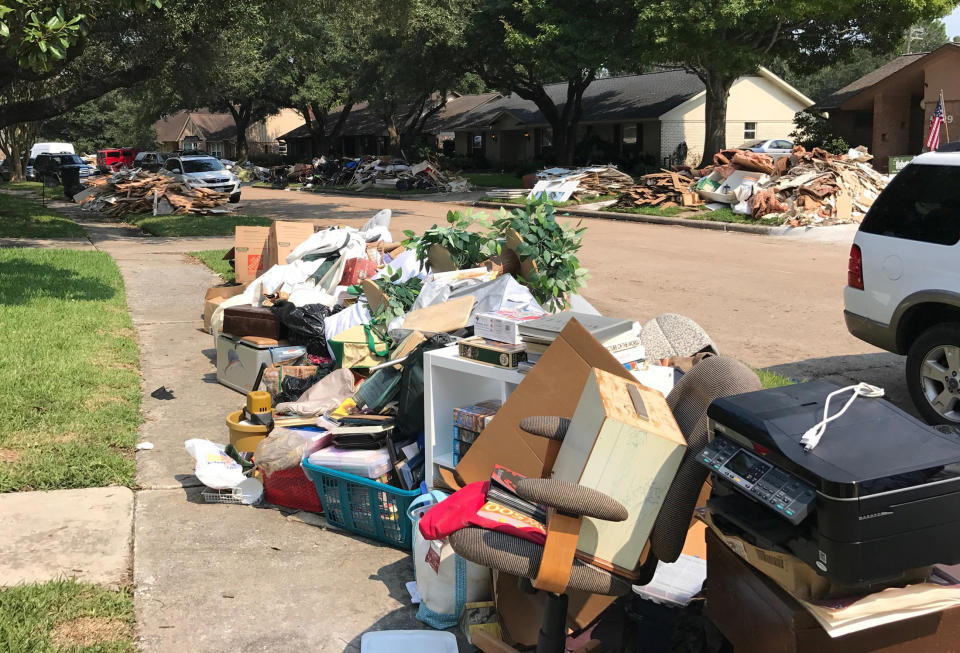 Damaged furniture, carpets and flooring are piled at a curbside on Sept. 2.