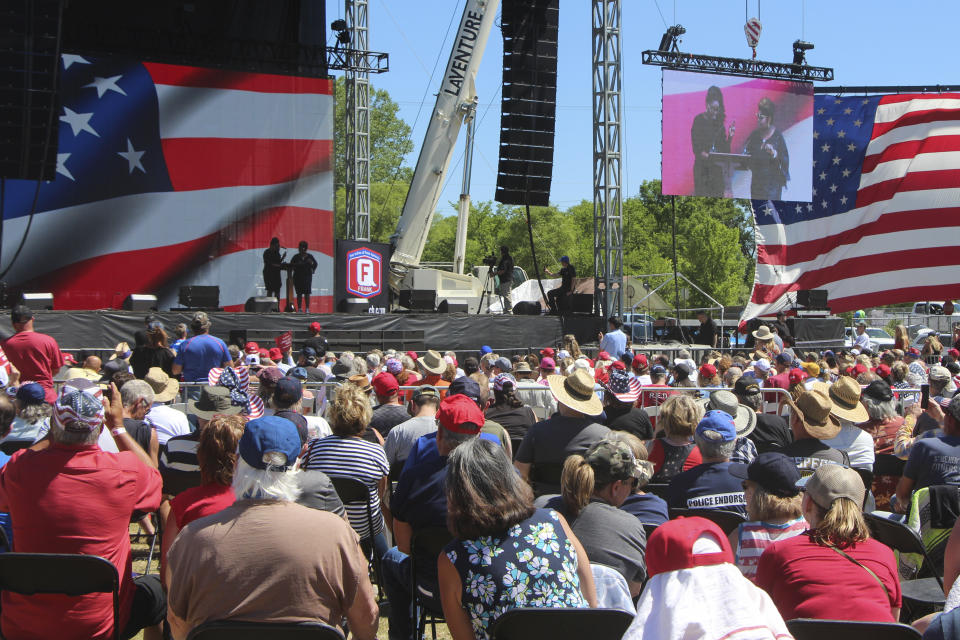 Diamond and Silk on stage at a rally organized by Mike Lindell in New Richmond, Wis., on Saturday, June 12, 2021, where he and other speakers disputed the results of the 2020 election. They frequently appeared at former President Donald Trump's campaign rallies as well. For a few hours last weekend, thousands of Donald Trump’s loyal supporters came together under the blazing sun in a field in western Wisconsin to live in an alternate reality where the former president was still in office — or would soon return.(AP Photo/Jill Colvin)