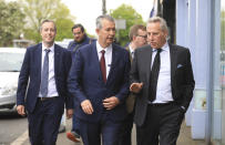 Democratic Unionist Party members Edwin Poots, centre, Paul Girvan, left, and Ian Paisley jnr leave the party headquarters in east Belfast after voting took place to elect a new leader on Friday May 14, 2021. Edwin Poots and Jeffrey Donaldson are running to replace Arlene Foster. (AP Photo/Peter Morrison)