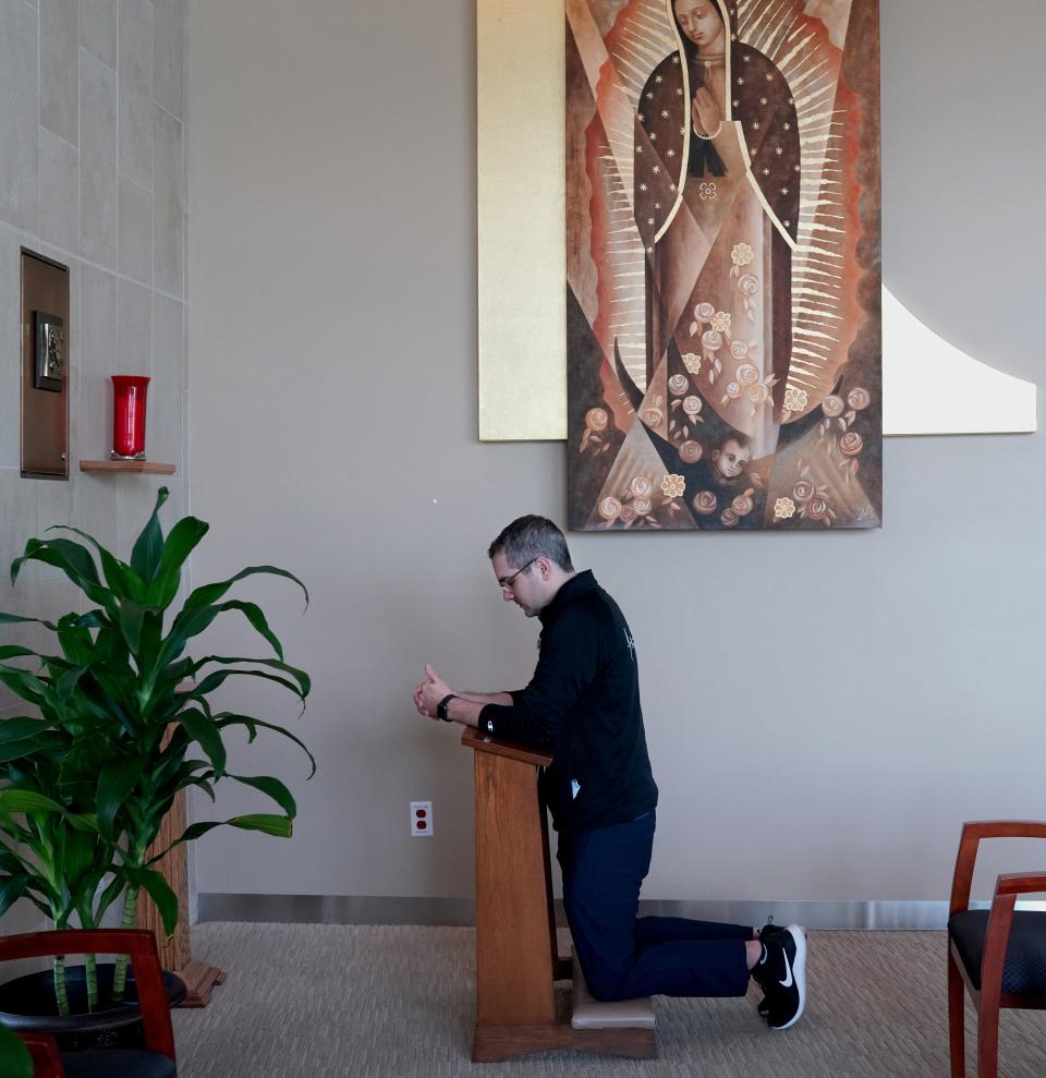 Chaplain Kevin Deegan prays while inside the Providence Holy Cross Medical Center chapel on Friday, Feb. 12, 2021, in Los Angeles. "We're beyond a point of feeling like this is crazy, and this is beyond unprecedented," he said about the COVID-19 pandemic. A year into the pandemic, "as we look ahead, we see a little bit of light at the end of the tunnel with the vaccine rolling out. But with these new strains, these new variants, it still feels like there's still a lot of dark days ahead."