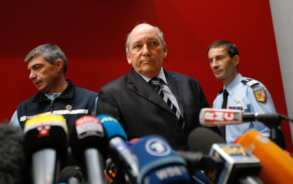 Albertville prosecutor Patrick Quincy, center, arrives with investigators for a press conference in the Albertville law court, French Alps, Wednesday Jan. 8, 2014. Two minutes of footage from a camera on Michael Schumacher's ski helmet showed the Formula One great was clearly skiing off a groomed trail when he lost his balance and crashed, leaving him with critical head injuries, investigators said Wednesday. The investigators said they have ruled out problems with his skis, trail conditions and signage. Although they would not estimate Schumacher's speed, they said it was not considered a significant factor in the Dec. 29 crash at the Meribel resort in the French Alps. (AP Photo/Claude Paris)