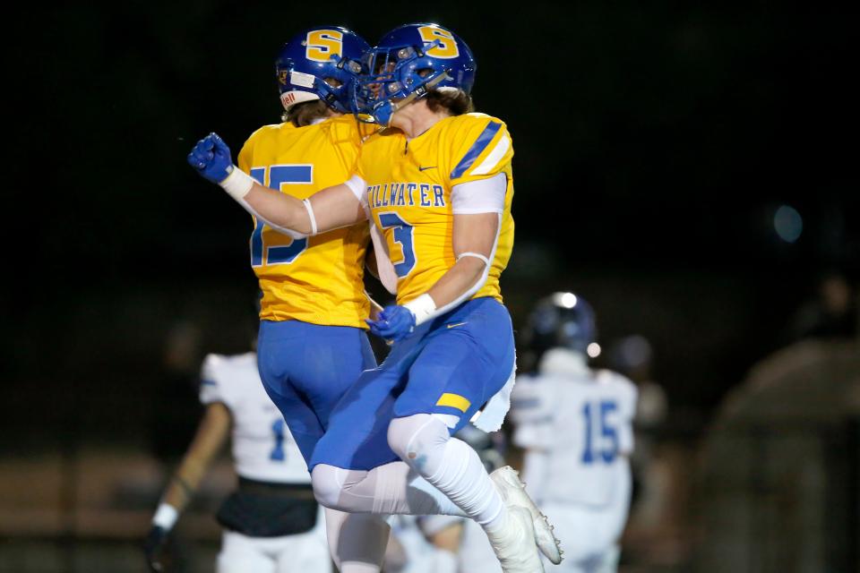 Stillwater's Heston Thompson (15) celebrates his touchdown catch with Talon Kendrick (3) during last season's Class 6A-II state semifinal in Ponca City.