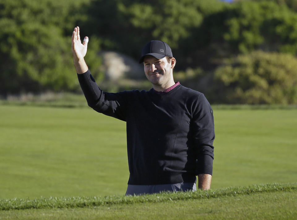 FILE - In this Feb. 9, 2018, file photo, Tony Romo waves after hitting the ball out of a bunker and close to the pin on the 11th green of the Monterey Peninsula Country Club Shore Course during the second round of the AT&T Pebble Beach National Pro-Am golf tournament, in Pebble Beach, Calif. Romo is finally in the Super Bowl. After being unable to lead Dallas to the big game, Romo will call the game for CBS in his second season in the booth. But just like Jared Goff and Tom Brady, Romo is coming in with plenty of momentum after his call of the AFC Championship game _ where he predicted many of New England's plays and tendencies _ drew universal accolades. (AP Photo/Eric Risberg, File)