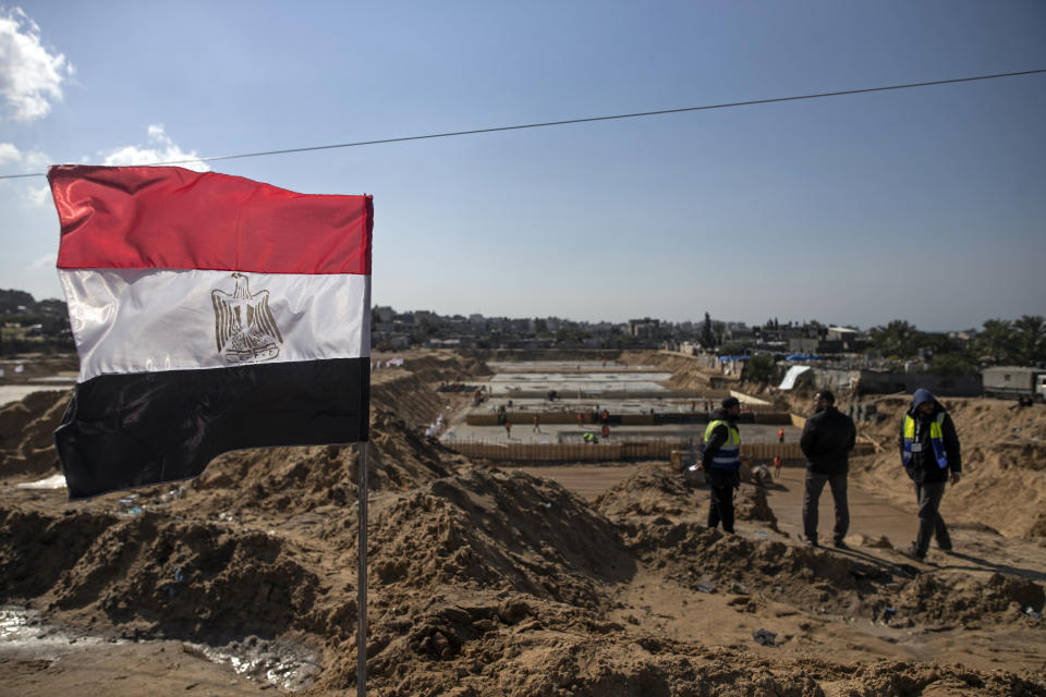 Laborers work on concrete slab foundations for one of three Egyptian-funded housing complexes in the Gaza Strip, in the town of Beit Lahiya, northern Gaza, Tuesday, Jan. 25, 2022. After years of working behind the scenes as a mediator, Egypt is taking on a much larger and more public role in Gaza. In the months since it brokered a Gaza cease-fire last May, Egypt has sent crews to clear rubbled and promised to build vast new apartment complexes, and billboards of its president Abdel-Fattah el-Sissi, are a common sight. (AP Photo/Khalil Hamra)