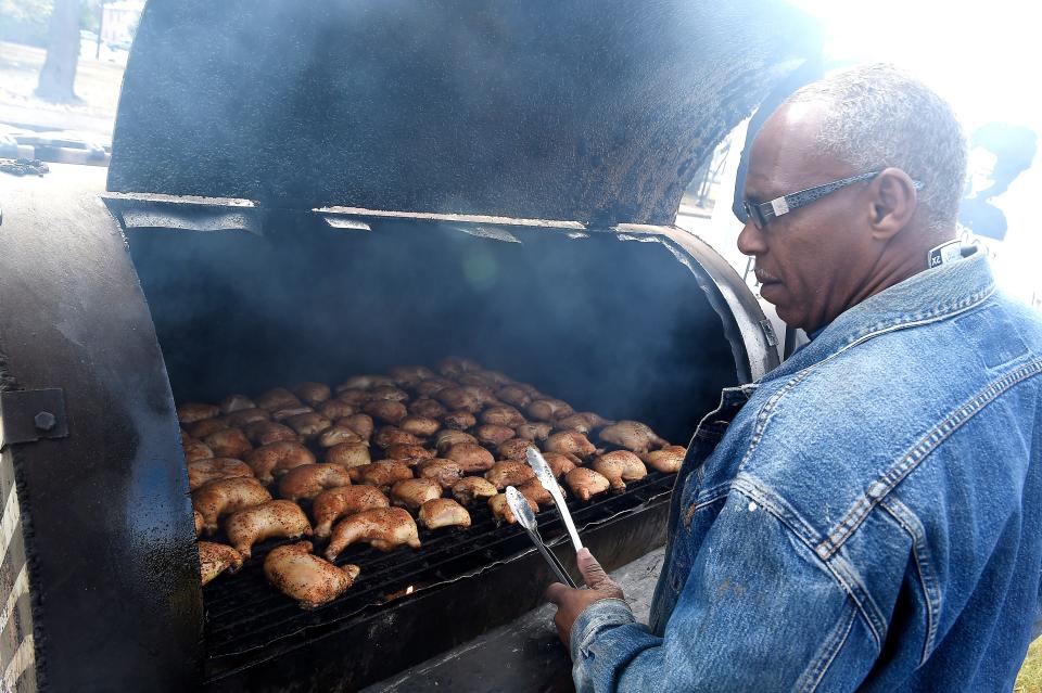 Barbecue man Freddie Waller tends to some leg quarters, which he sells for $1 at Ooh Wee Bar-B-Q at 2008 Jefferson St.