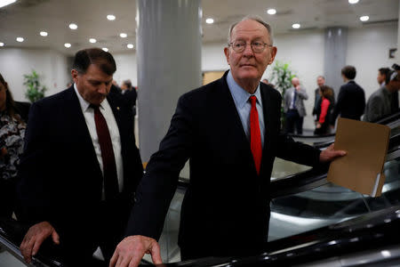 Sen. Lamar Alexander (R-TN) and Sen. Mike Rounds (R-SD) walk to the party luncheons on Capitol Hill in Washington, U.S. January 23, 2018. REUTERS/Aaron P. Bernstein