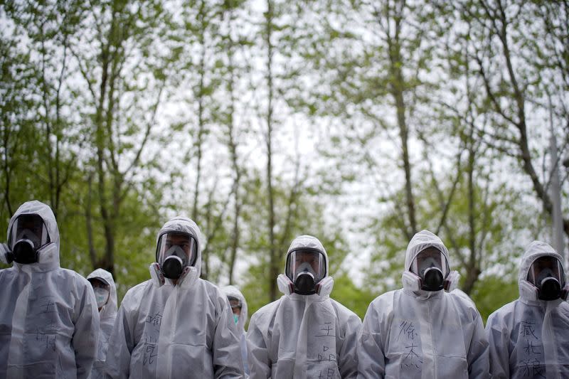 Volunteers from the Blue Sky Rescue team wearing protective suits is seen at the Qintai Grand Theatre in Wuhan