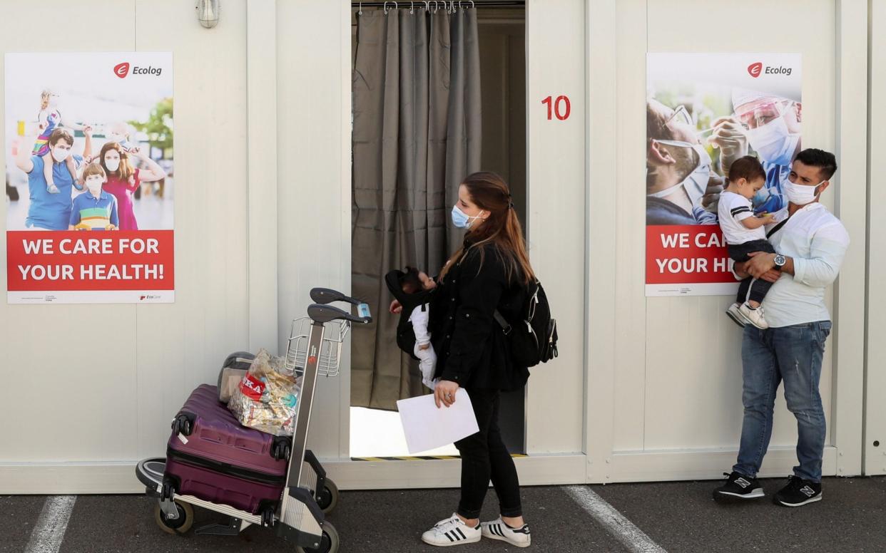 Travellers wait for coronavirus tests at Zaventem Airport in Brussels - Yves Herman/Reuters