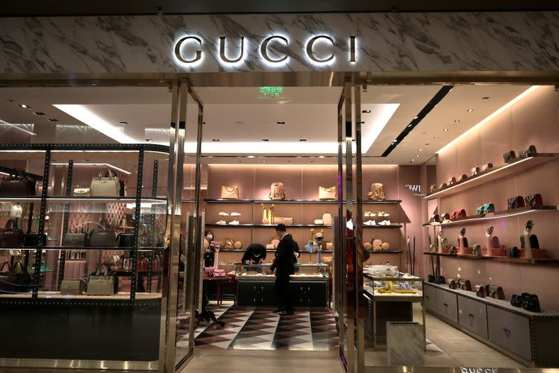 FILE PHOTO: Staff members wearing face masks are seen inside a store of an Italian luxury brand Gucci at a shopping mall, as the country is hit by an outbreak of the novel coronavirus, in Beijing