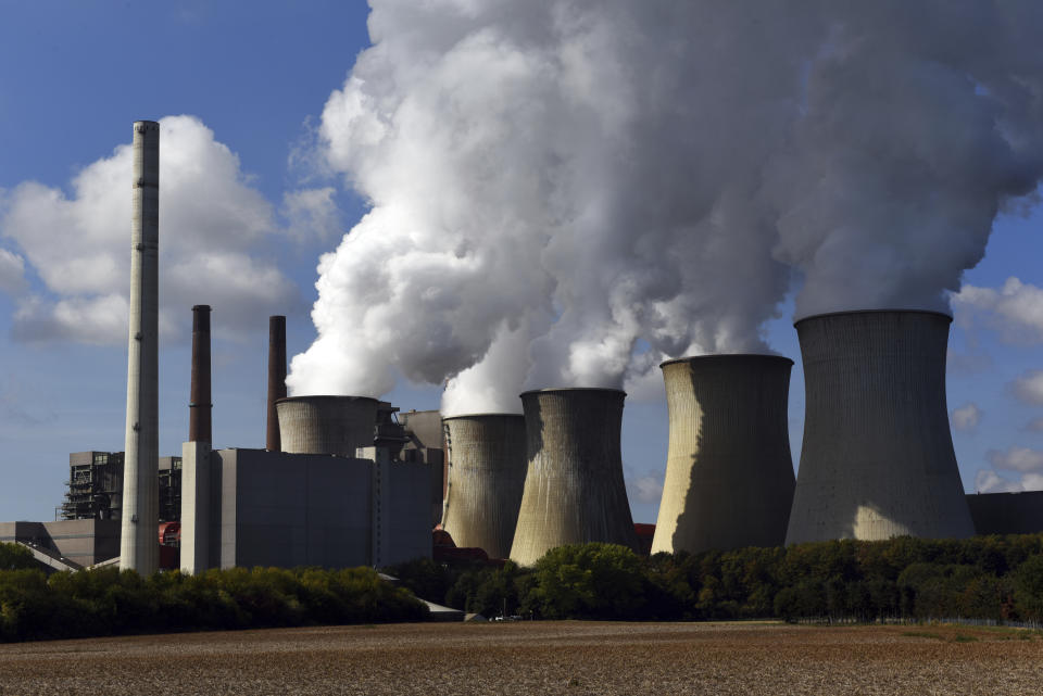 FILE -- In this Sept. 25, 2018 photo steam swells from the cooling towers of the RWE lignite-fired Neurath power plant in Grevenbroich, Germany. German energy company RWE says it won’t invest in new coal-fired power stations and is scrapping plans for a lignite-fired plant in western Germany. (Horst Ossinger/dpa via AP, file)