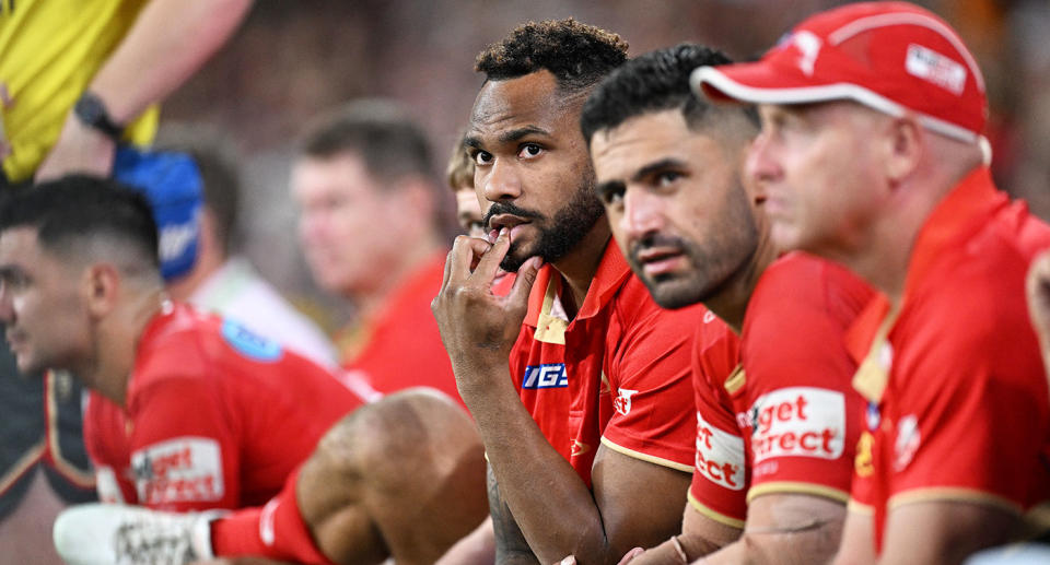 Pictured centre, Dolphins fullback Hamiso Tabuai-Fidow watches from the sidelines after hobbling off against Brisbane with a hamstring injury.