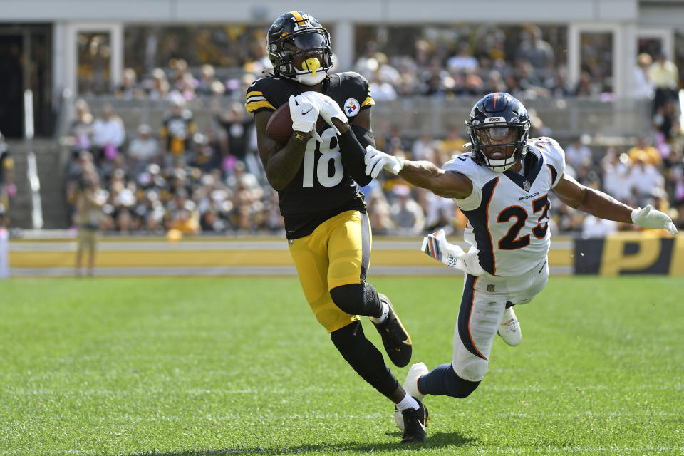 Pittsburgh Steelers wide receiver Diontae Johnson (18) hauls in a pass from quarterback Ben Roethlisberger with Denver Broncos cornerback Kyle Fuller (23) defending during the first half of an NFL football game against the Denver Broncos in Pittsburgh, Sunday, Oct. 10, 2021. Johnson took the ball in for a touchdown. (AP Photo/Don Wright)