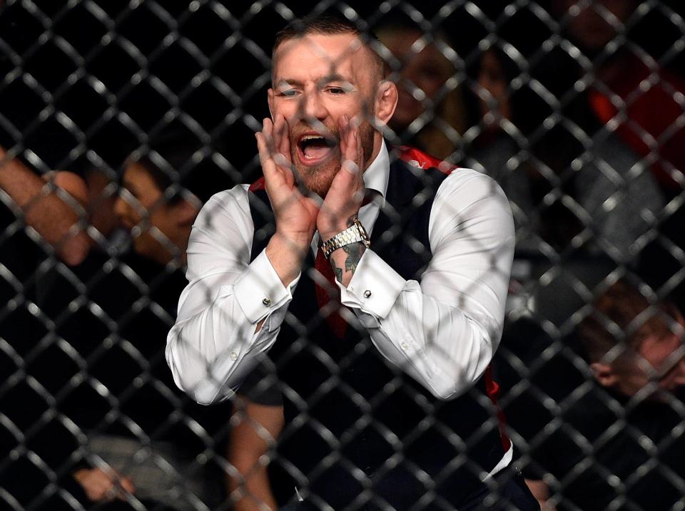 Conor McGregor yells outside the cage during a match. (Getty)