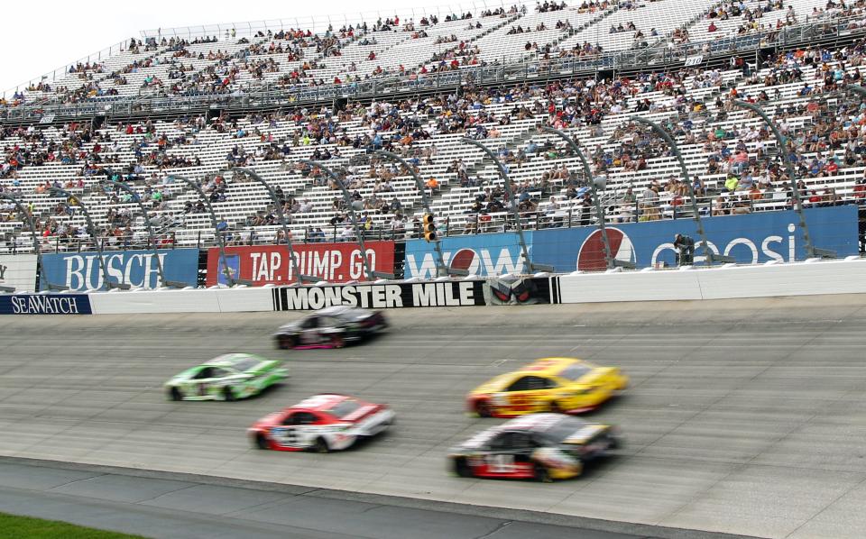 NASCAR Cup Series cars race during the 2018 playoff race at Dover International Speedway.