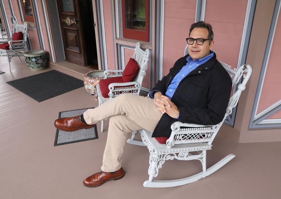 Michael Hall Lombardi, sits on the porch of the Armour-Stiner (Octagon) House in Irvington, April 18, 2019. This unique home, a house museum on the National Register of Historic Places, is now open to visitors.