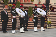 U.S. Secretary of State Mike Pompeo, left, and Secretary of Defence Mark Esper arrive to pay their tributes at the National War Memorial in New Delhi, India, Tuesday, Oct. 27, 2020. In talks on Tuesday with their Indian counterparts, Pompeo and Esper are to sign an agreement expanding military satellite information sharing and highlight strategic cooperation between Washington and New Delhi with an eye toward countering China. (Jewel Samad/Pool via AP)