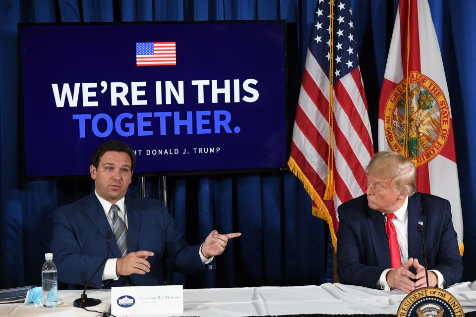 US President Donald Trump (R) and Florida's governor Ron DeSantis hold a COVID-19 and storm preparedness roundtable in Belleair, Florida, July 31, 2020. (Photo by SAUL LOEB / AFP) (Photo by SAUL LOEB/AFP via Getty Images)