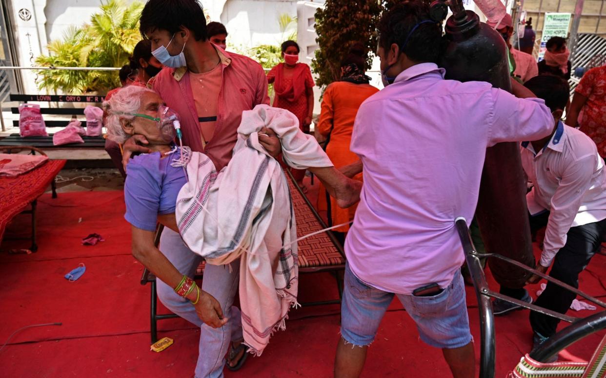 Patients are being treated in tents set up on roads as hospitals are overwhelmed - Tauseef Mustafa/AFP