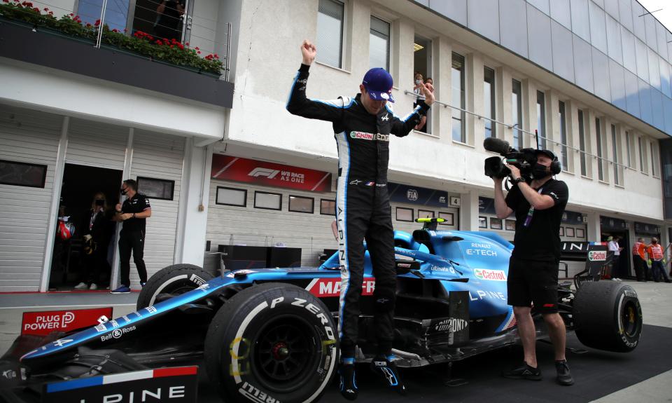 Alpine driver Esteban Ocon of France celebrates with his team after winning the Hungarian Formula One Grand Prix at the Hungaroring racetrack in Mogyorod, Hungary, Sunday, Aug. 1, 2021. (Florion Goga/Pool via AP)