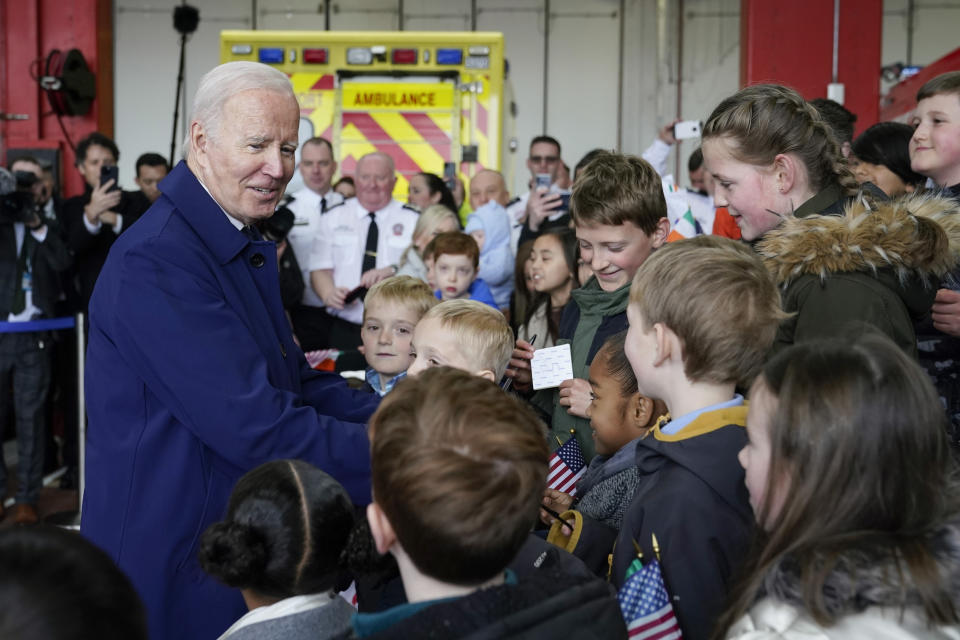 President Joe Biden greets children of embassy staff at Dublin International Airport in Dublin, Ireland, Wednesday, April 12, 2023. (AP Photo/Patrick Semansky)